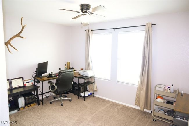 Office area with carpet, a wealth of natural light, a ceiling fan, and baseboards | Image 24