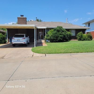 View of front of property featuring a carport and a front lawn | Image 1