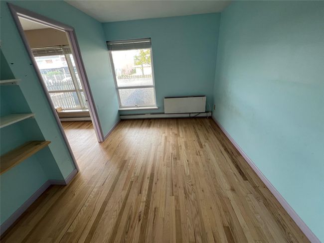 Empty room with baseboards, healthy amount of natural light, and wood finished floors | Image 4