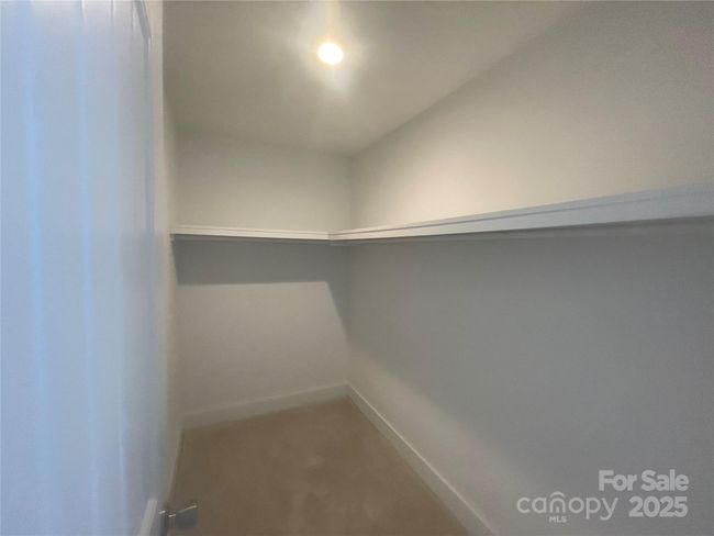 Walk in closet in Primary bedroom. | Image 9