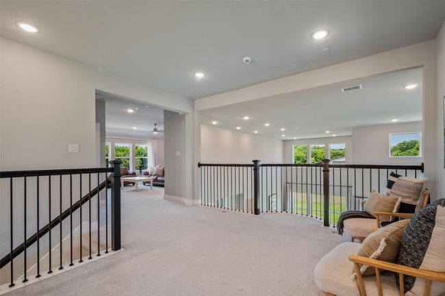 Upstairs loft overlooks the downstairs living area and leads into the upstairs living space. . | Image 24