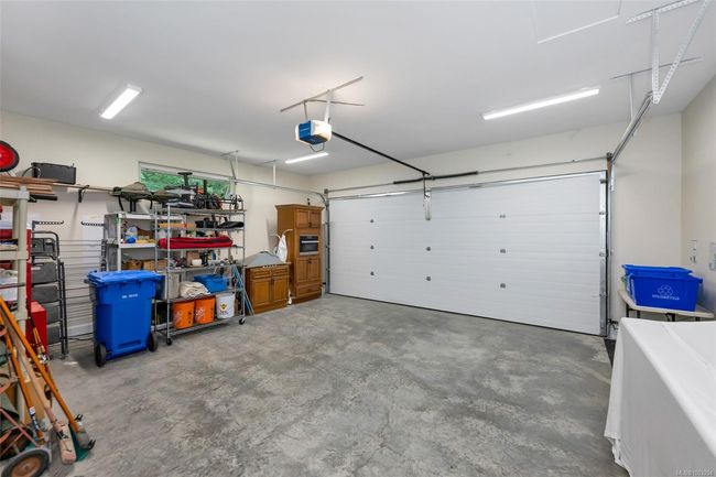 Garage featuring a garage door opener | Image 81