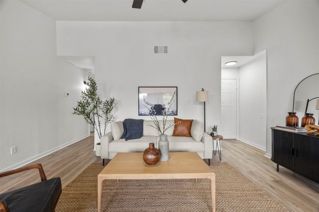 Living room featuring light wood-style flooring and ceiling fan | Image 22