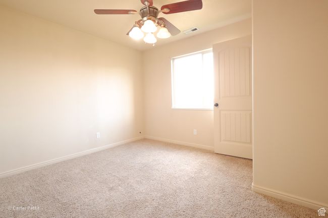 Empty room with carpet and ceiling fan | Image 12