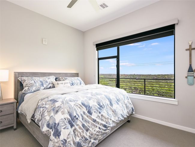 This guest bedroom in the front of the unit is large enough for this king-size bed, includes an upgraded ceiling fan, and enjoys gorgeous sunset views. | Image 19