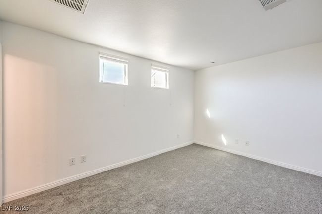 Below grade area featuring carpet, baseboards, and visible vents | Image 39