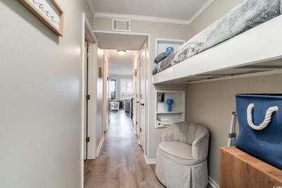 Corridor featuring wood-type flooring and ornamental molding | Image 2