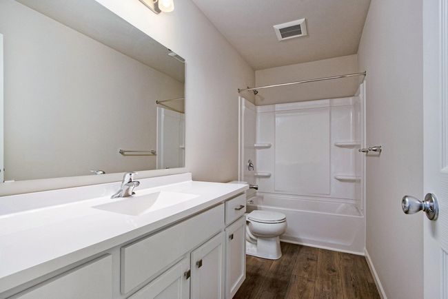 There is full bathroom is centrally located and has a tub/shower combo. | Image 16