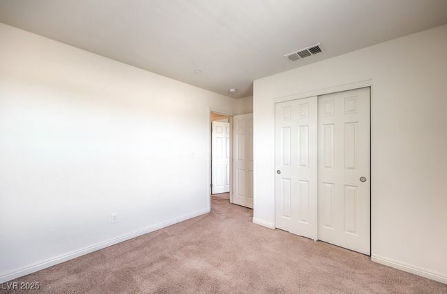 Unfurnished bedroom featuring light colored carpet, a closet, visible vents, and baseboards | Image 27