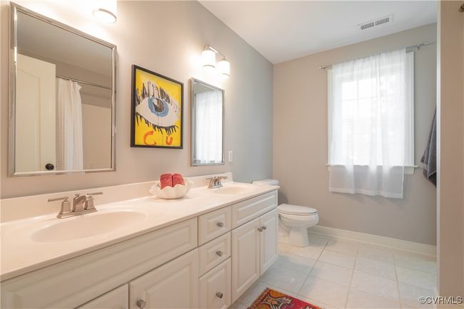 Bathroom with baseboards, a sink, visible vents, and toilet | Image 29
