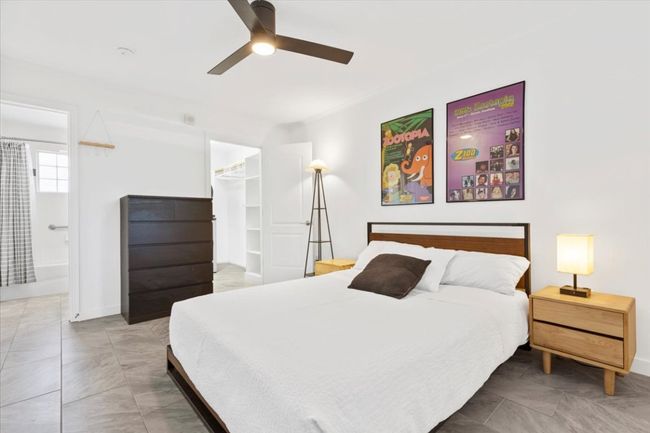 Bedroom featuring a walk in closet, ensuite bath, and ceiling fan | Image 14