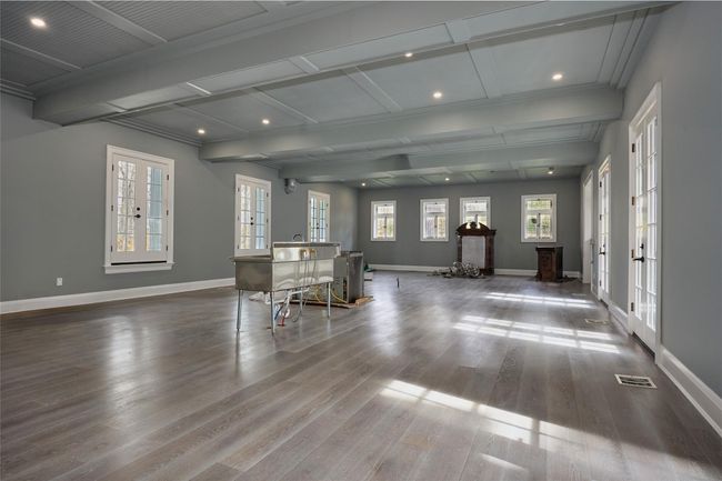 Living area featuring wood finished floors, recessed lighting, coffered ceiling, and baseboards | Image 19