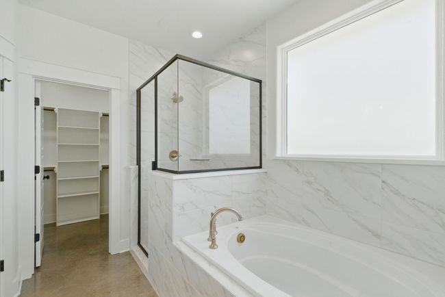 Bathroom with a bath, a marble finish shower, and a walk in closet | Image 15