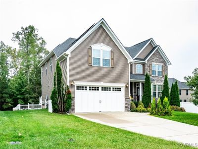 Craftsman house with a front yard and a garage | Image 1