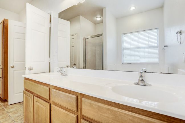 Full bathroom featuring a shower stall and double vanity | Image 11