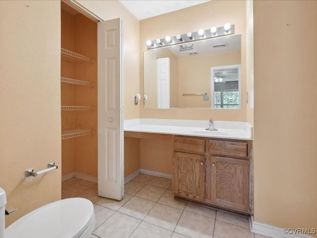 Bathroom with tile patterned floors, vanity, and a ceiling fan | Image 20