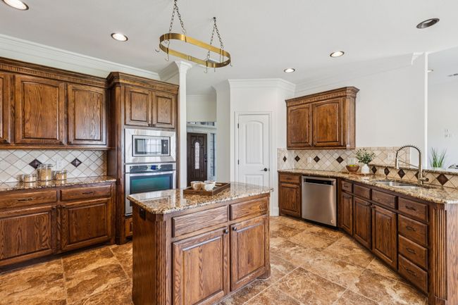 A view of the stainless steel appliances including dishwasher, oven and microwave. | Image 14
