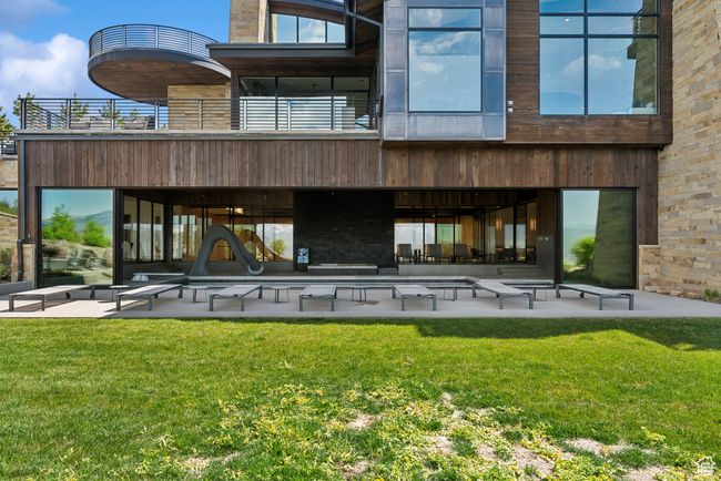 Rear view of property featuring a patio area, a yard, and a balcony | Image 66
