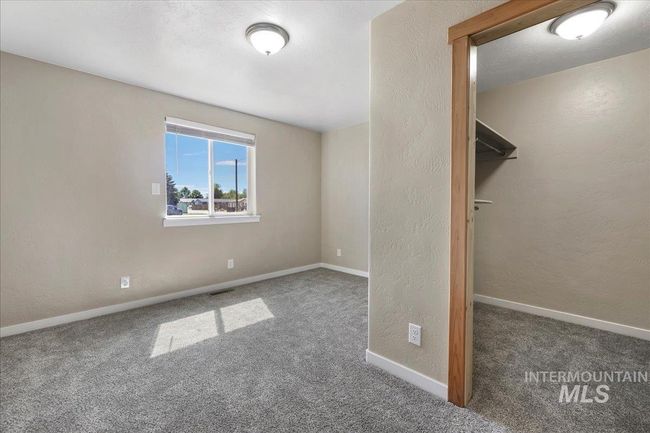 Unfurnished bedroom with carpet flooring and a textured wall | Image 9