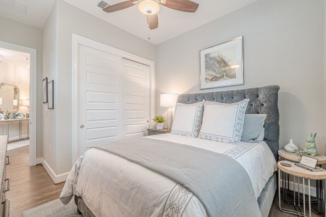 Bedroom with a closet, wood finished floors, baseboards, and ceiling fan | Image 20