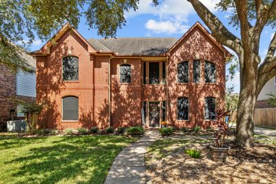 Charming two-story brick residence with timeless appeal. | Image 1