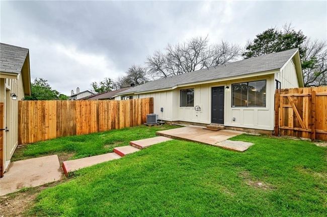 Rear view of house featuring central AC unit, a patio, roof with shingles, and board and batten siding | Image 13