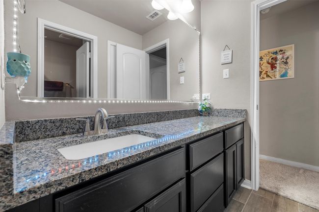 Bathroom featuring vanity and baseboards | Image 24