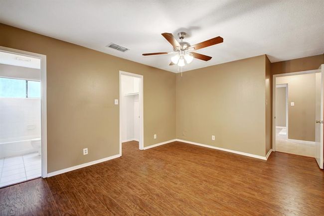 View of the primary bedroom showing closet and bathroom locations | Image 20