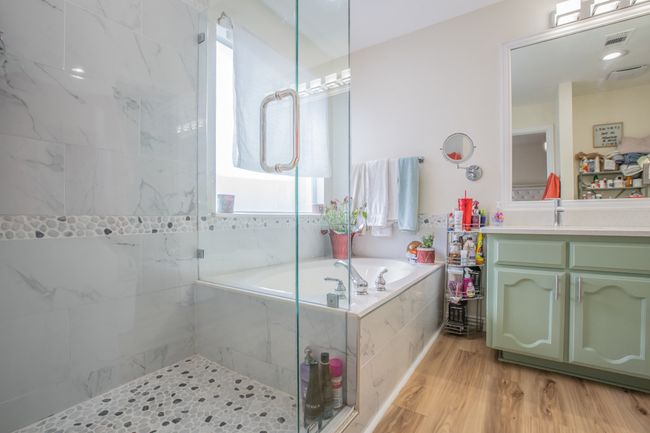 Bathroom with a bath, walk in shower, visible vents, and vanity | Image 12