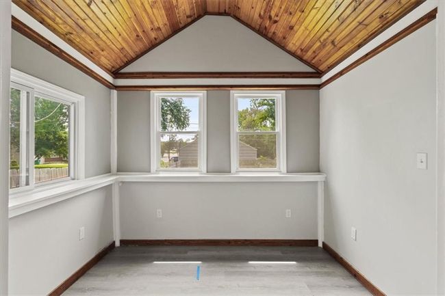 Spare room with lofted ceiling, wood ceiling, and wood finished floors | Image 9