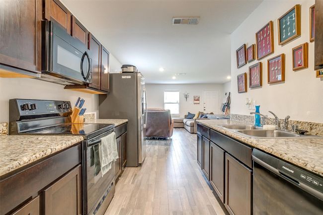 Kitchen featuring granite countertops, open floor plan, and recessed lighting | Image 14