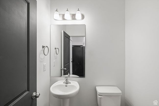 Bathroom featuring toilet and a sink | Image 16