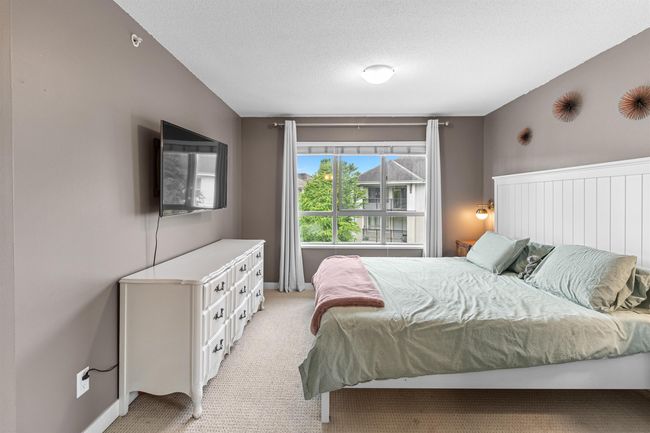 Bedroom with light carpet and a textured ceiling | Image 8