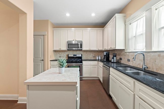 The kitchen island can be removed or moved. Bright cabinets and granite countertops. | Image 18