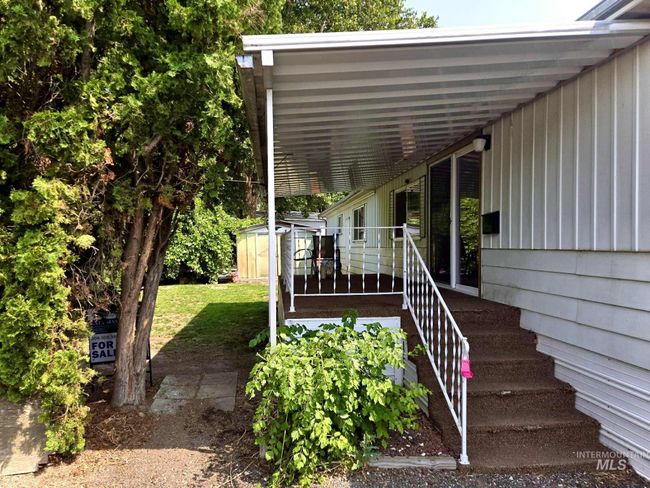 Doorway to property featuring a lawn | Image 17