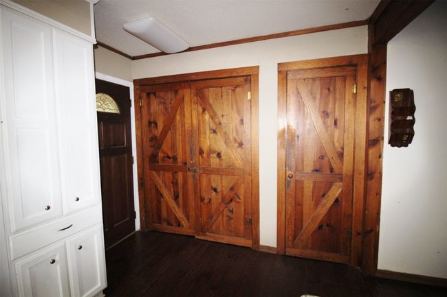 Double doors lead to the laundry room. Single door leads to a walk-in pantry | Image 14