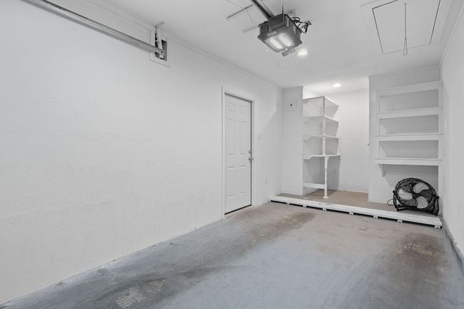 Single car garage with additional storage space. | Image 30