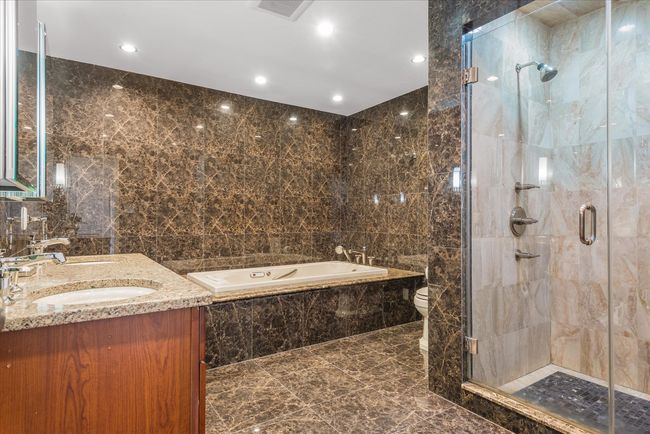 Full bathroom with a stall shower, visible vents, tile walls, a sink, and a bath | Image 10