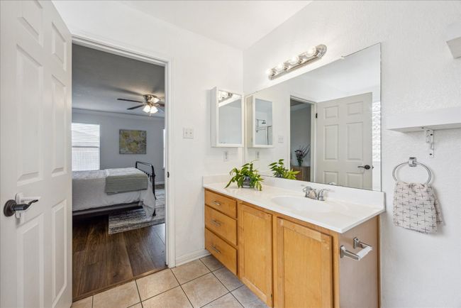 Ensuite bathroom with vanity, tile flooring, and track lighting | Image 16