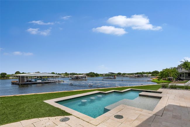 Swimming pool with a yard, a water view, and a patio area | Image 30