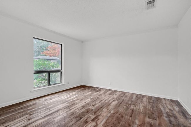 Spare room featuring wood finished floors and baseboards | Image 16
