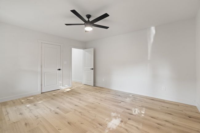 Unfurnished room featuring a ceiling fan, wood finished floors, and baseboards | Image 16