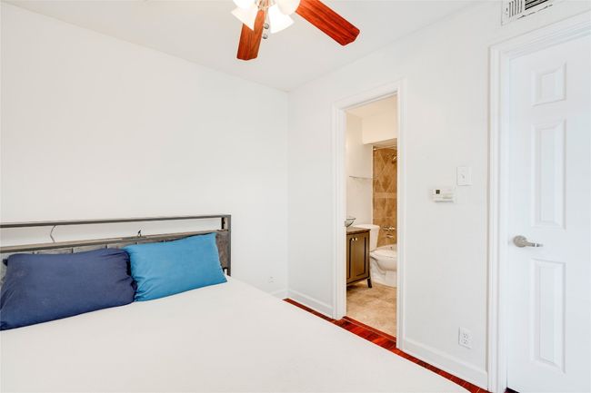 Unfurnished bedroom with ensuite bathroom, baseboards, and ceiling fan | Image 36