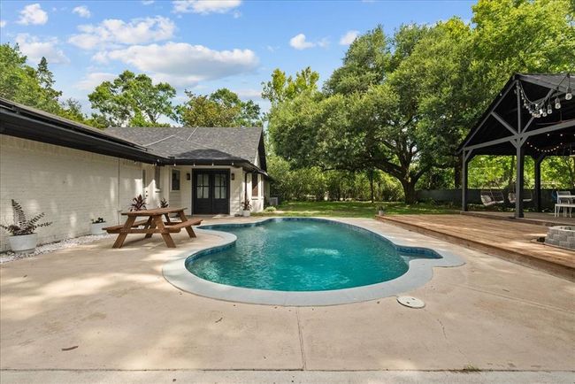 Refreshing in-ground pool with extended patio and pavilion access—your own private paradise! | Image 37