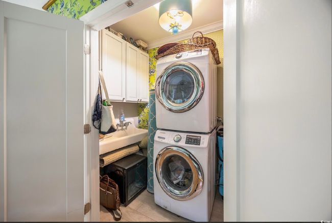 Washroom featuring stacked washer / dryer | Image 37