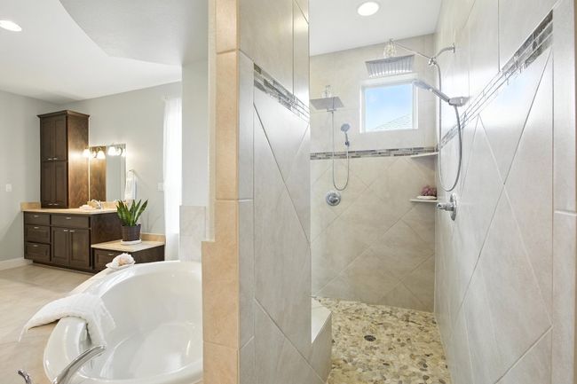 Bathroom featuring a garden tub, vanity, a walk in shower, and recessed lighting | Image 21