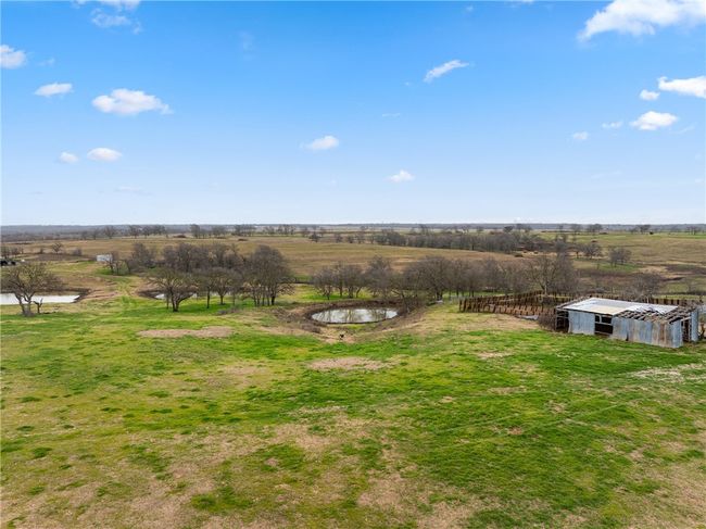 View of yard featuring an outdoor structure and a rural view | Image 23
