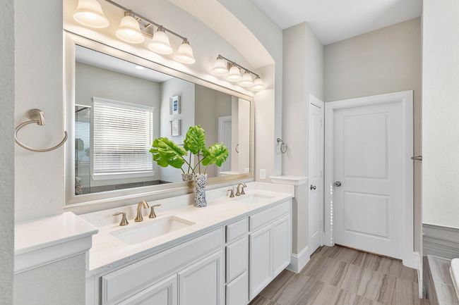 Start your day in style with this beautifully designed primary ensuite, complete with a custom Closets by Design layout for ultimate organization and elegance. | Image 24