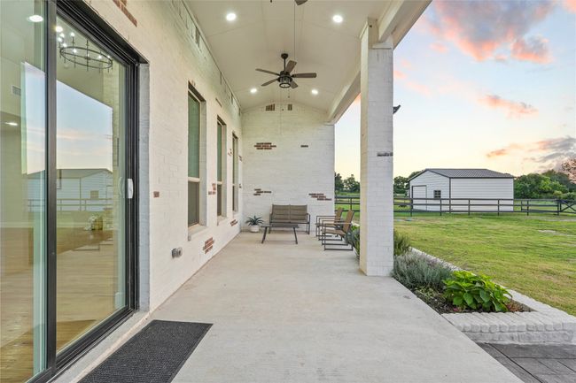 Patio terrace at dusk featuring a ceiling fan | Image 26