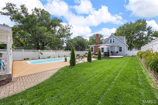 Fenced backyard featuring a patio area and a wooden deck | Image 37